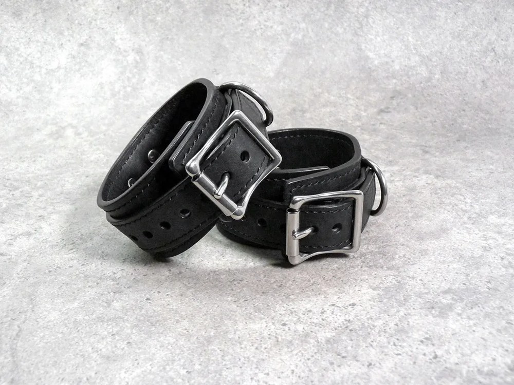 Pair of BDSM handcuffs in black and red leather, Dorcel style